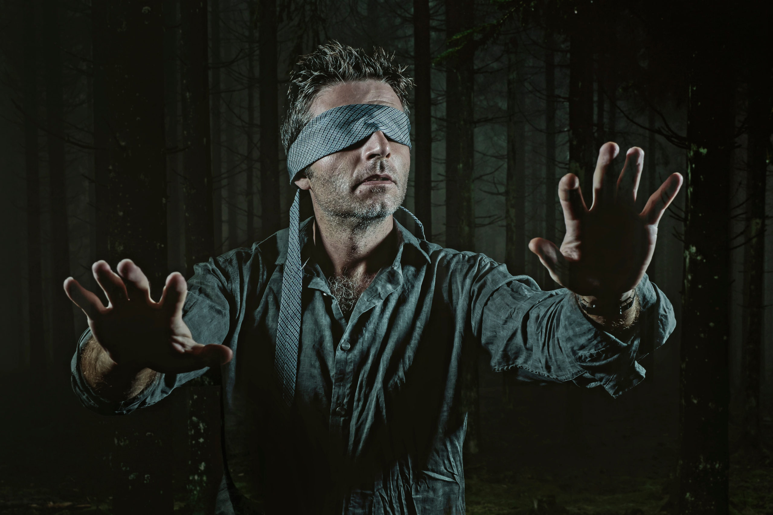 Young Confused And Scared Man Blindfolded With Necktie Playing Internet Trend Dangerous Viral Challenge With Eyes Blind Lost In Dark Forest Background Guided By Intuition By TheVisualsYouNeed Scaled